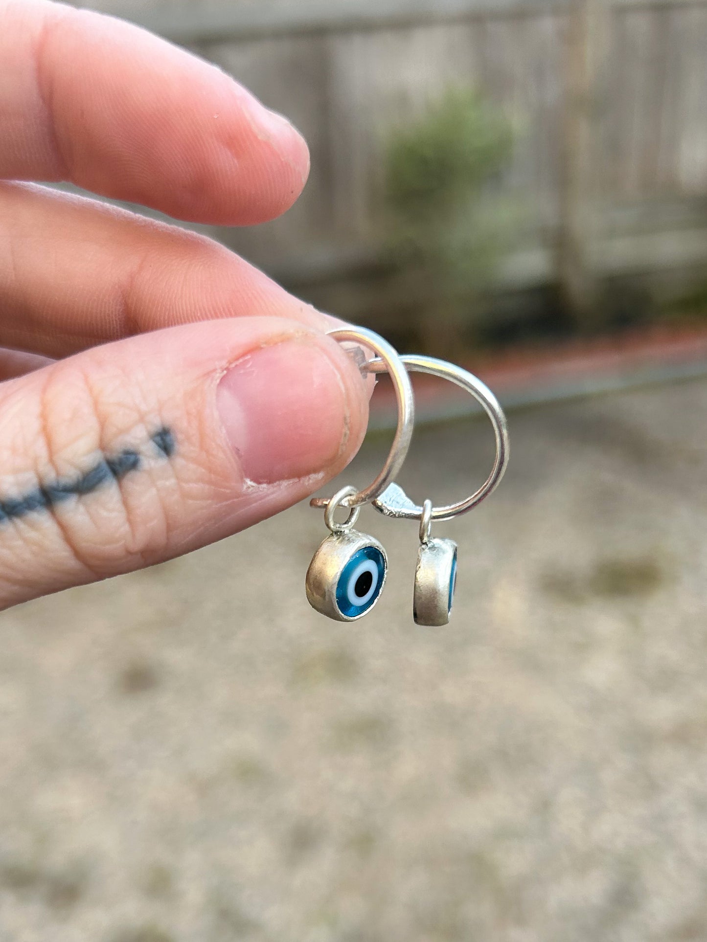 Small hoops with evil eye charms