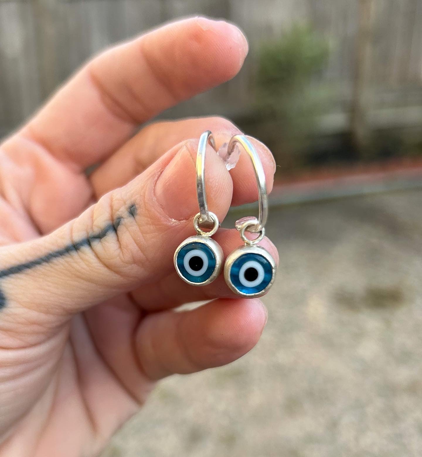 Small hoops with evil eye charms
