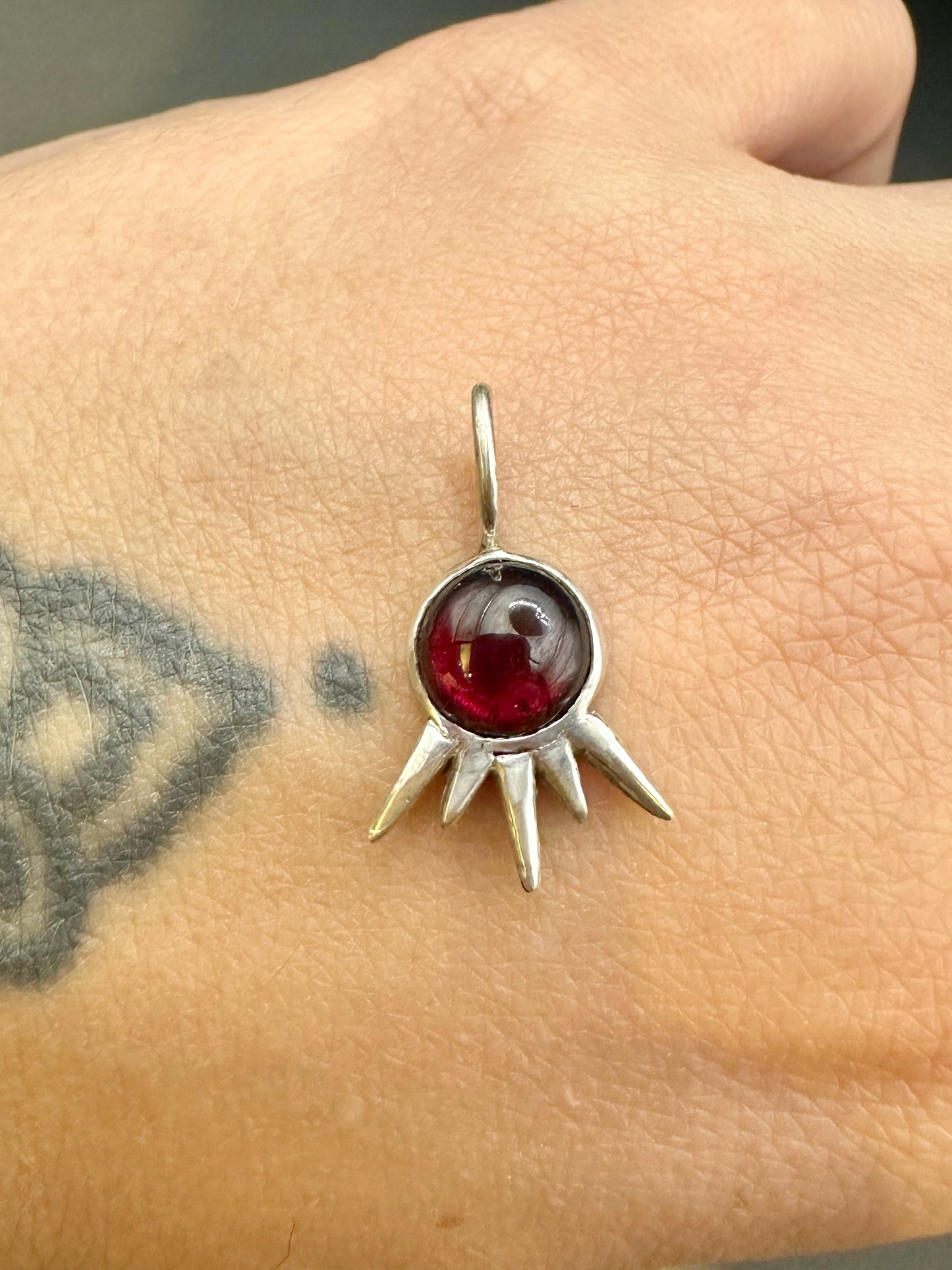 Garnet starburst charm