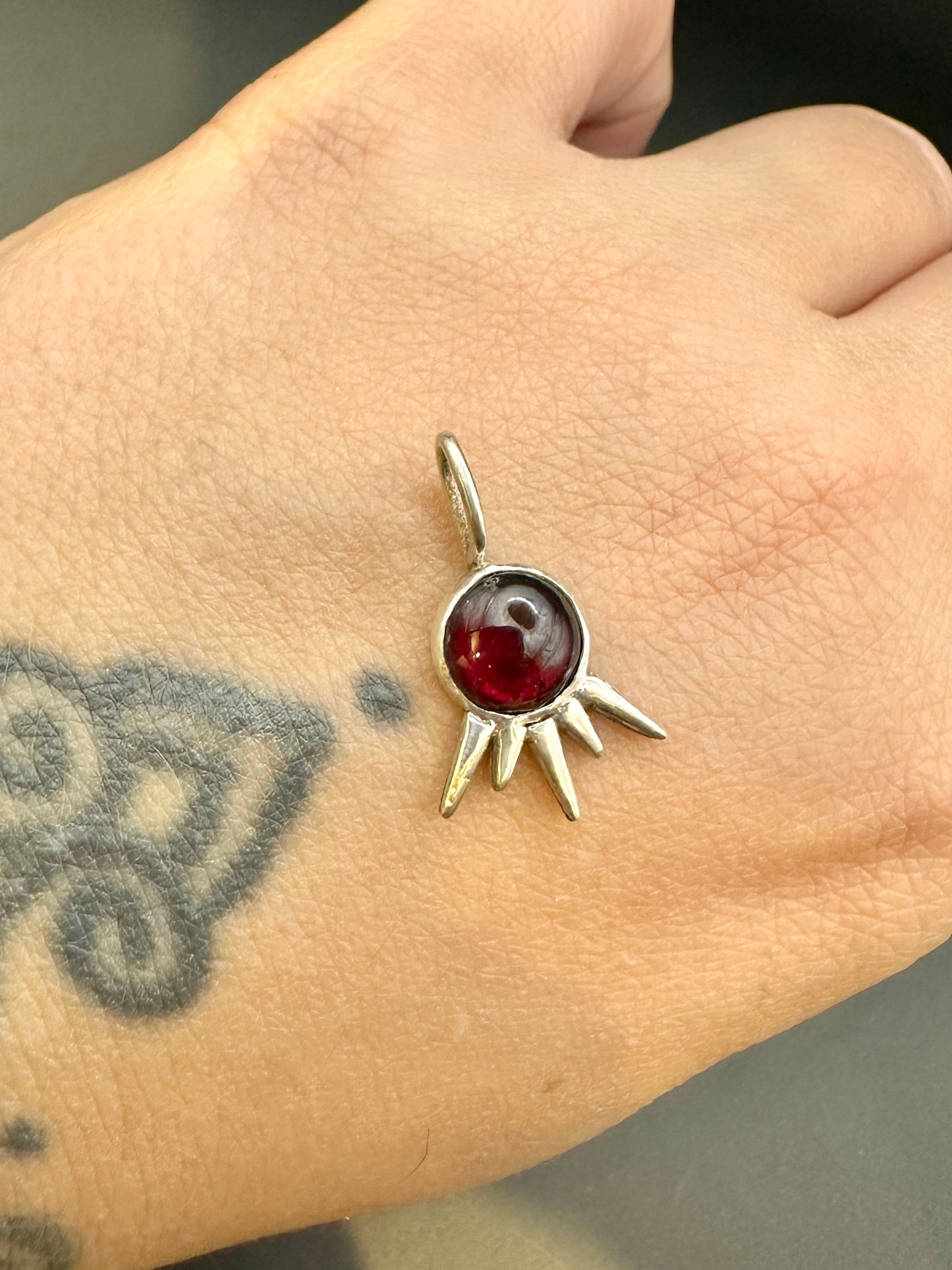 Garnet starburst charm